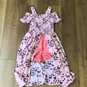 A pink and white striped romper with butterflies on it